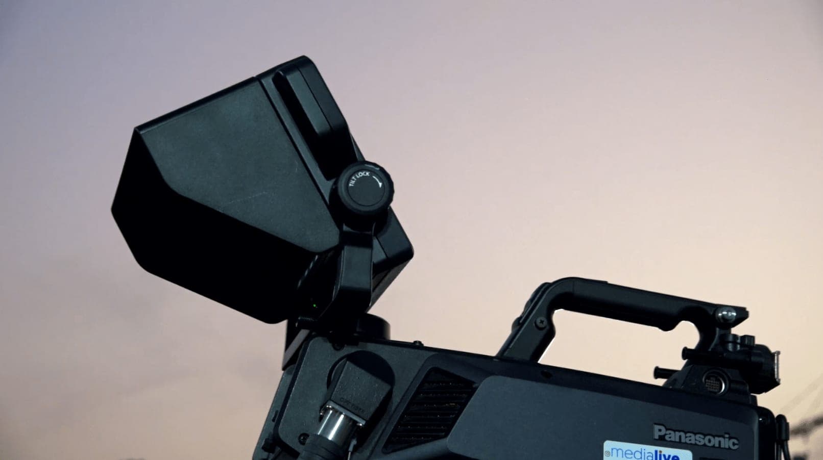 A Panasonic broadcast camera against the dusk sky at a Pi Video Pro live event